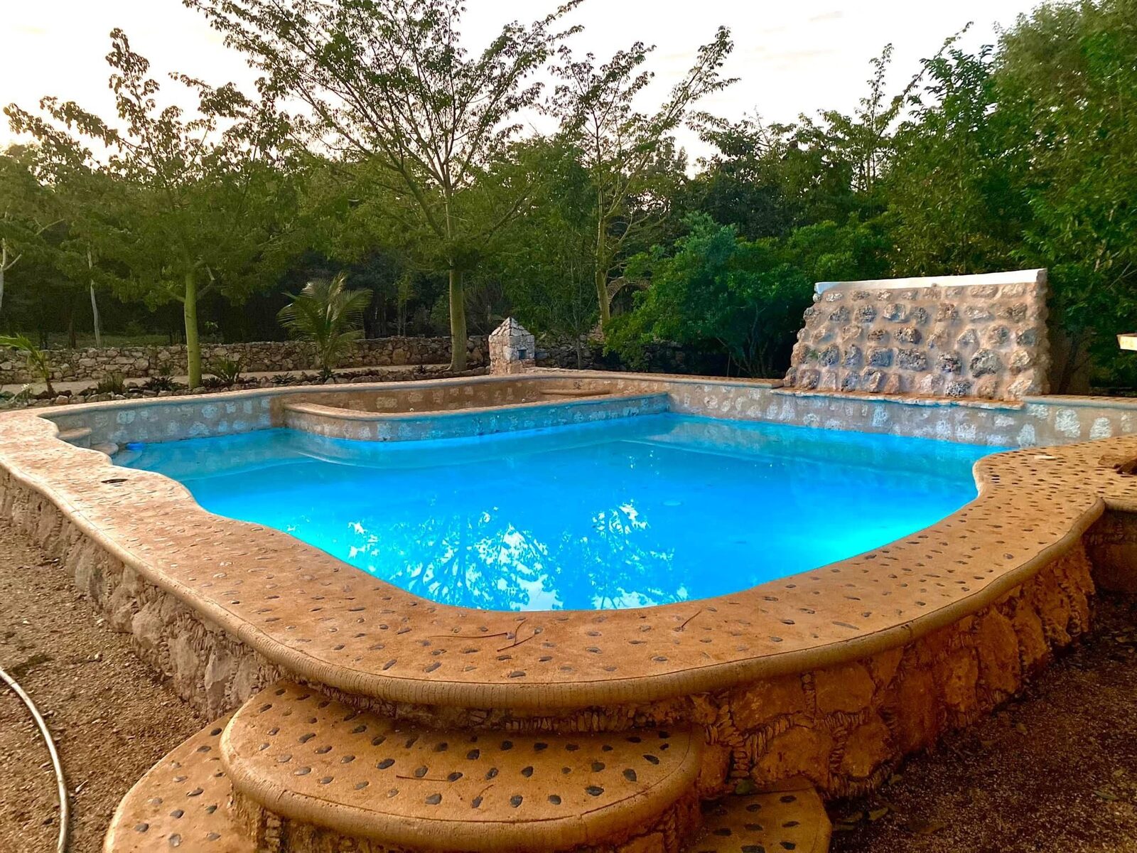 The same pool at sunset, the water catching the last warm light.